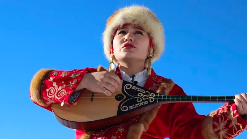 Sayagul Birlesbek plays domra, a lute-like instrument popular in Eastern Europe and Central Asia. 