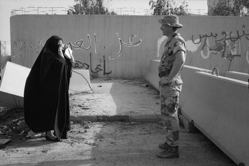 An American soldier being photographed by a Kuwaiti woman. Gulf War, Kuwait, 1991
