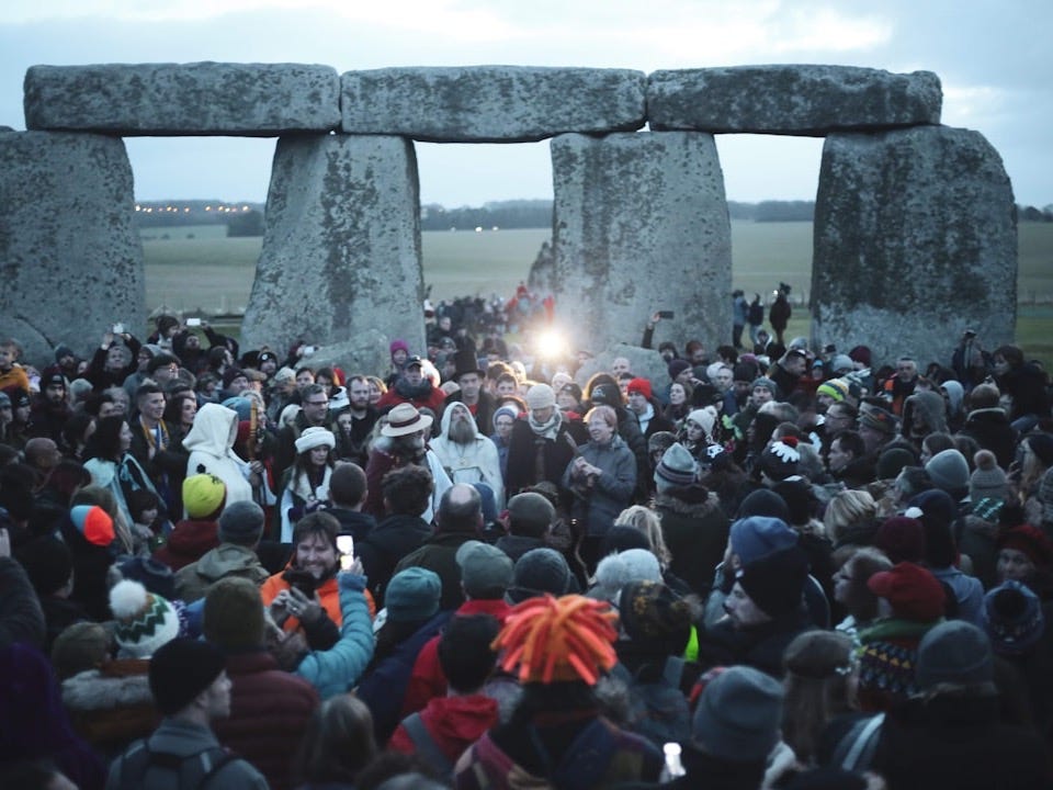 people gathering near gray concrete pillar during daytime
