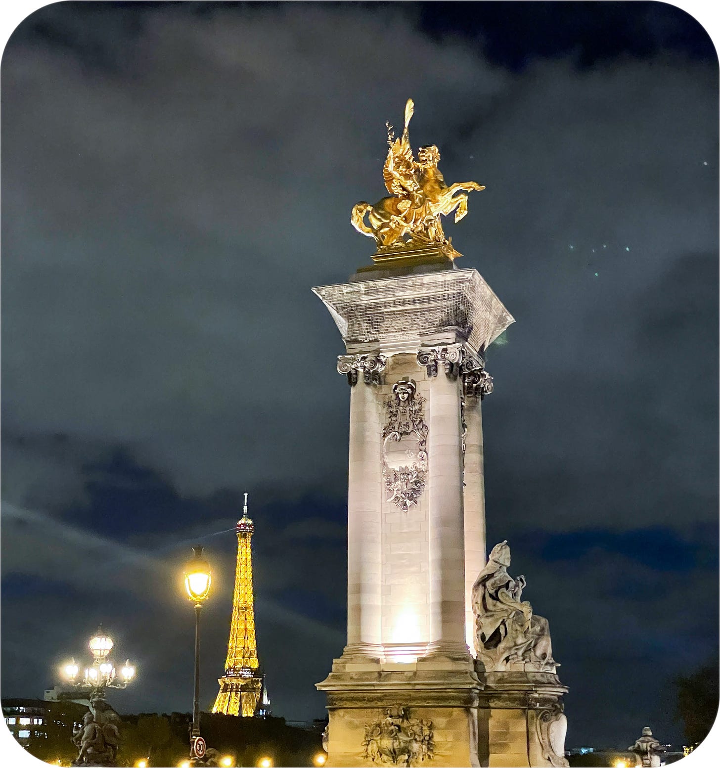 Pont Alexandre III and the Eiffel Tower at night.
