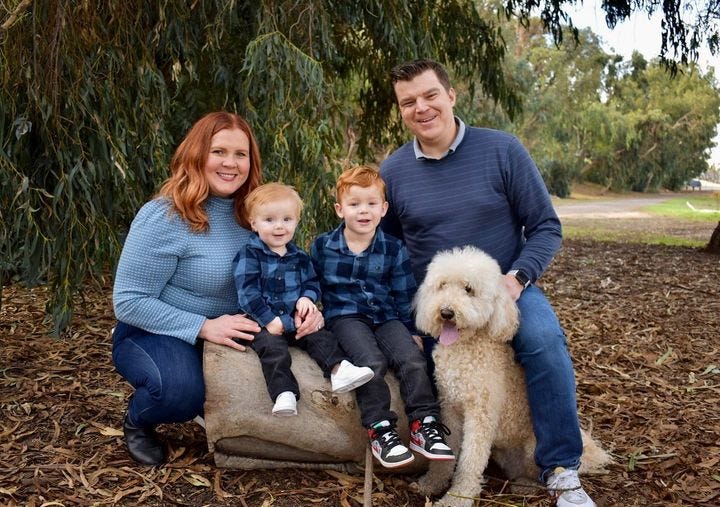 May be an image of 4 people, child, people sitting, people standing, outdoors and tree