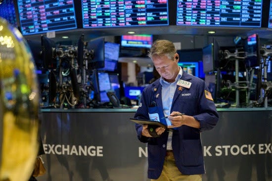 Traders work the floor at the New York Stock Exchange.