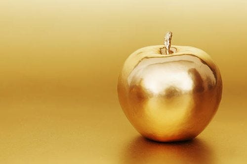 golden apple on gold background gold apple on gold background golden apple stock pictures, royalty-free photos & images