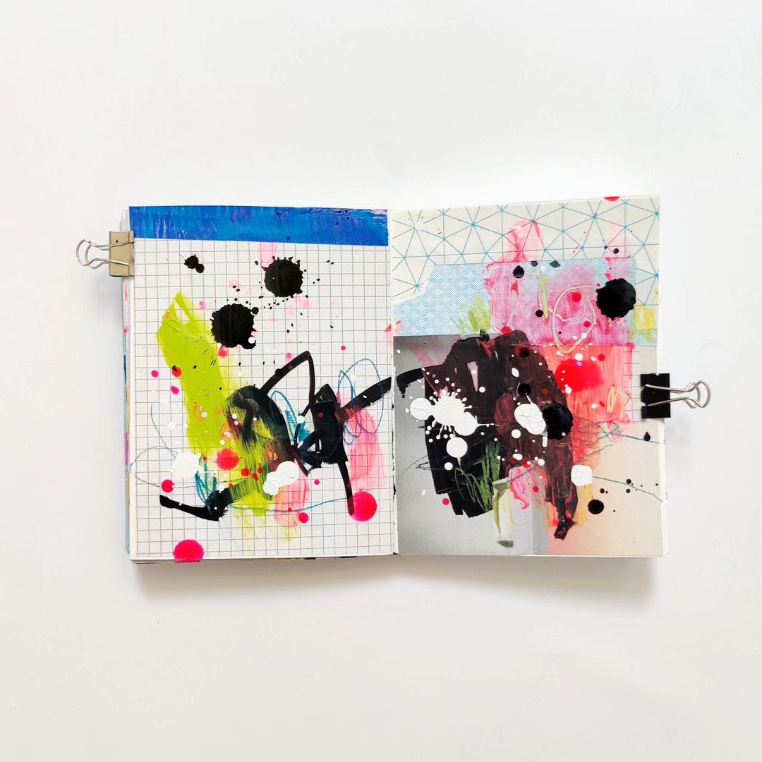 An open mixed media art journal with geometric collage and scribbles and splatter in neons and black.