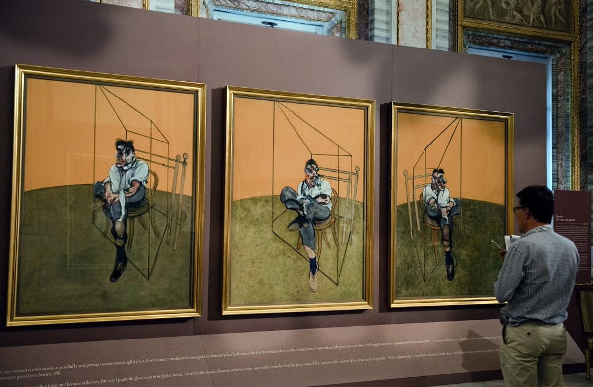 A man admires Francis Bacon’s painting “Three Studies of Lucian Freud."