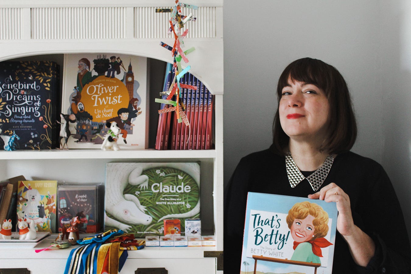 Photo of Jennifer M Potter with some of the books and cards she illustrated