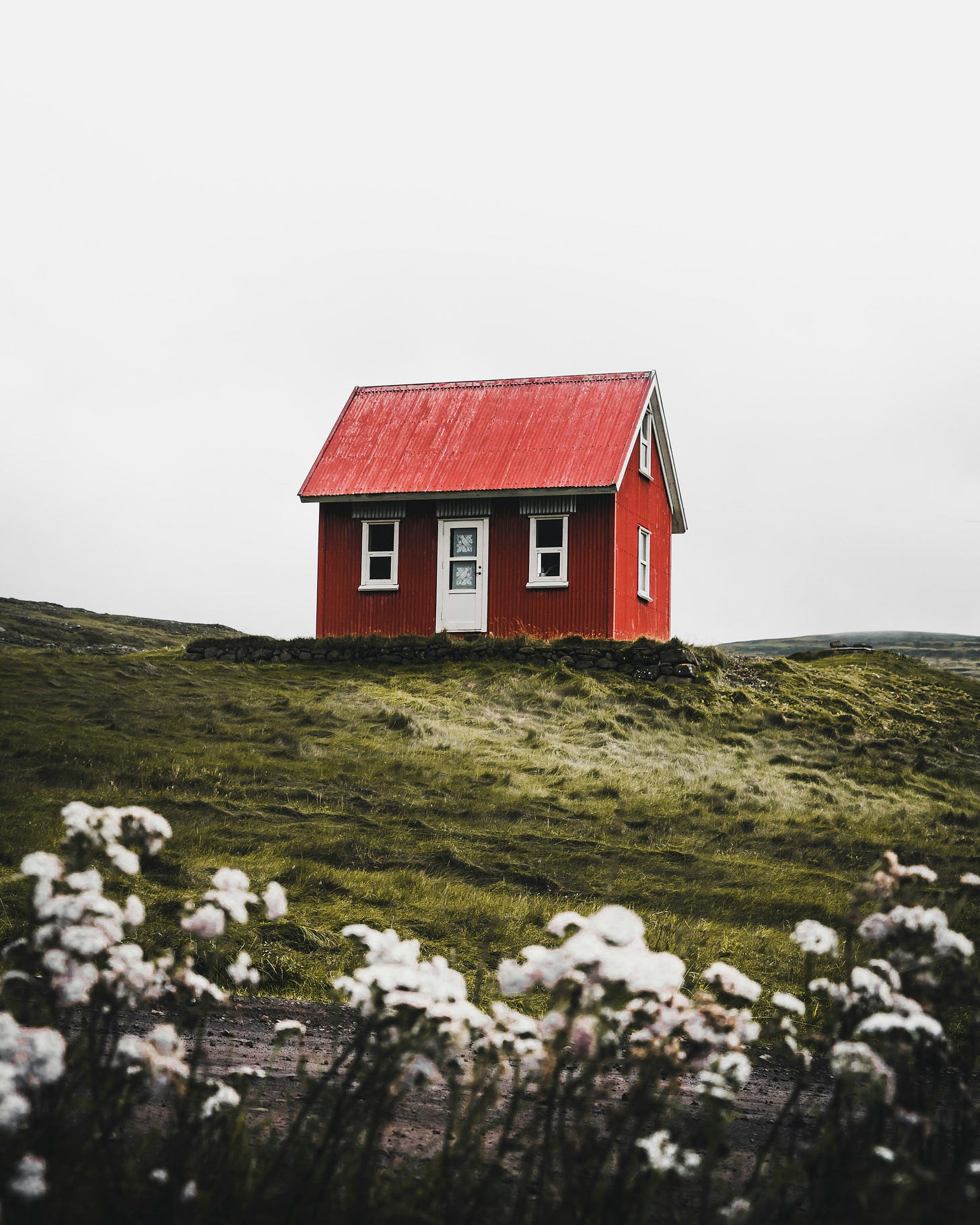 A small red house on a hill