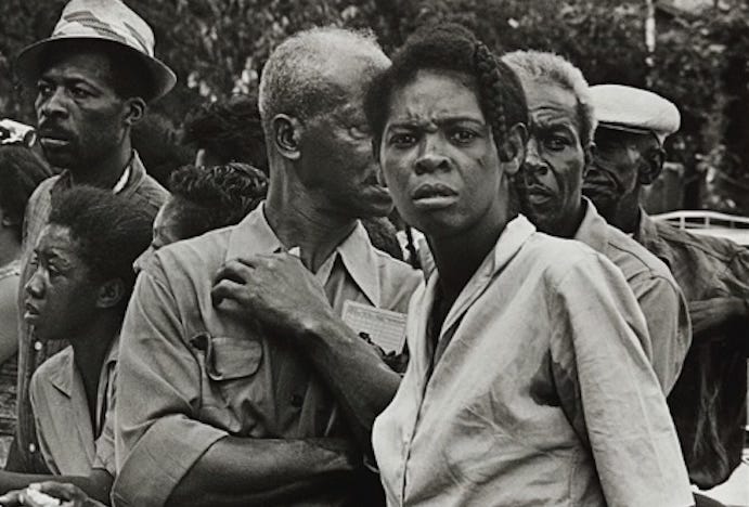 Photo by Danny Lyon of African American woman staring at the camera with an expression of outrage