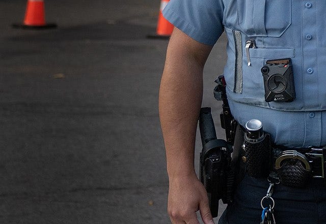 Focused view of an officer in uniform with their Axon camera attached