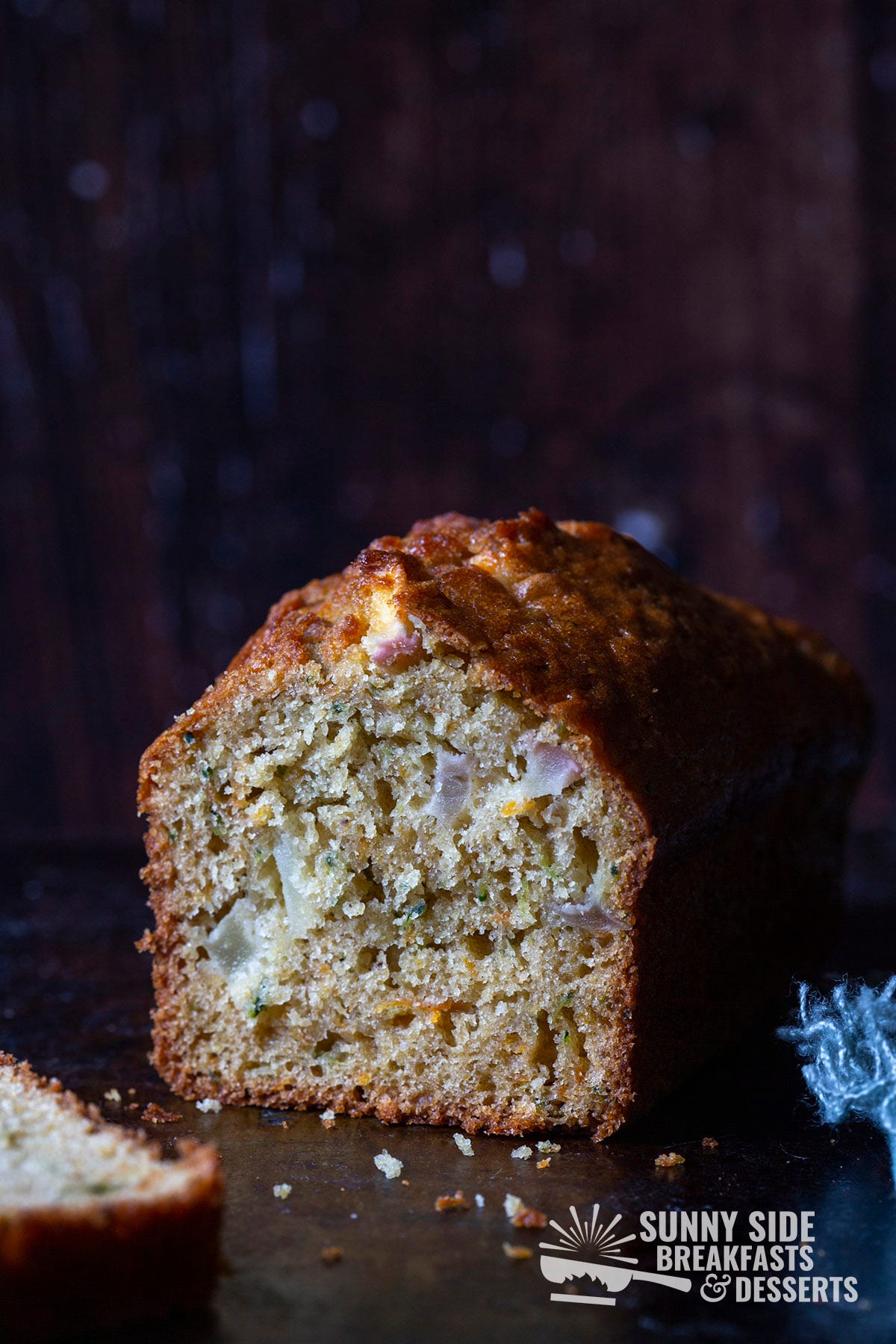 A loaf of apple carrot zucchini bread sliced open.