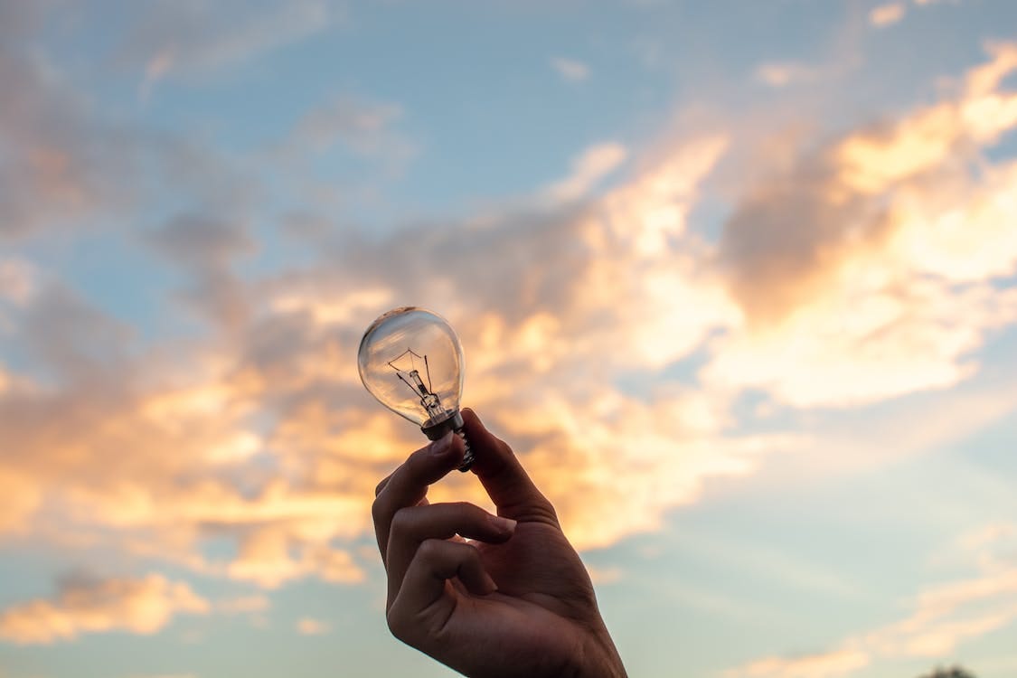 Free Person Holding Clear Light Bulb Stock Photo
