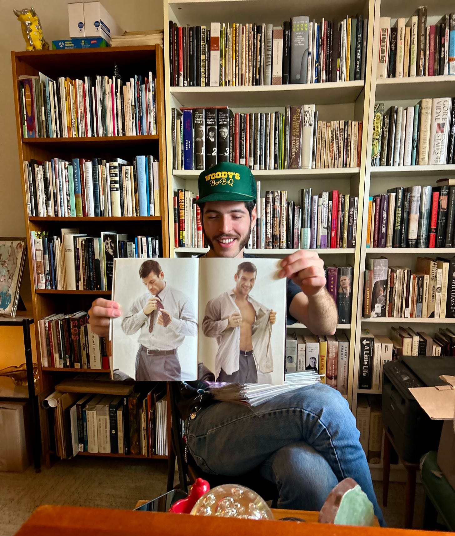 Daniel in Kirby's library sorting through vintage gay porn mags.