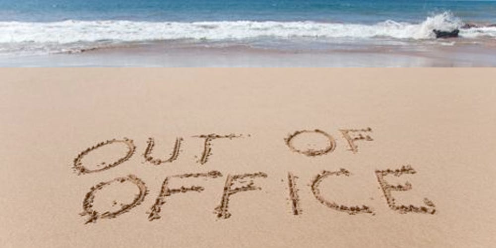 A beach with the words "Out of office" written into the sand.