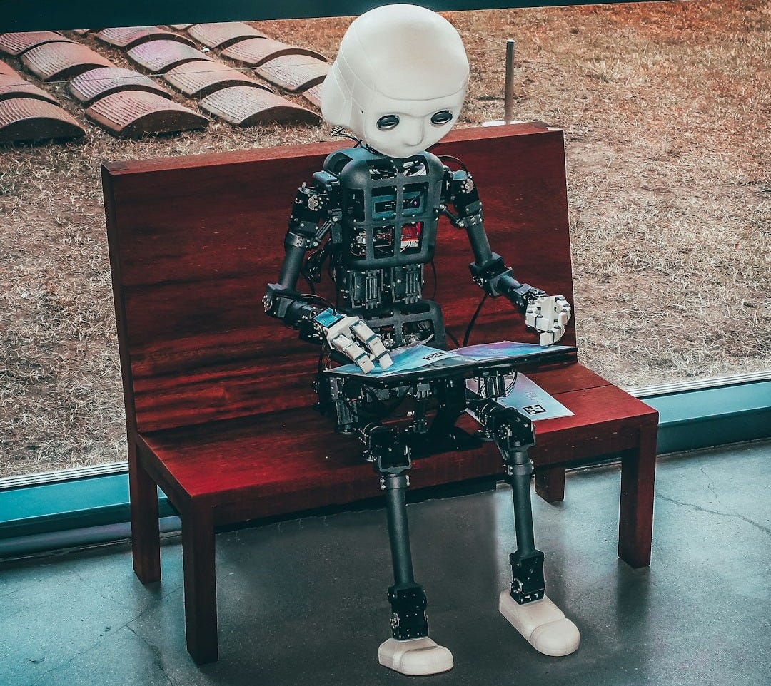 black and white robot toy on red wooden table