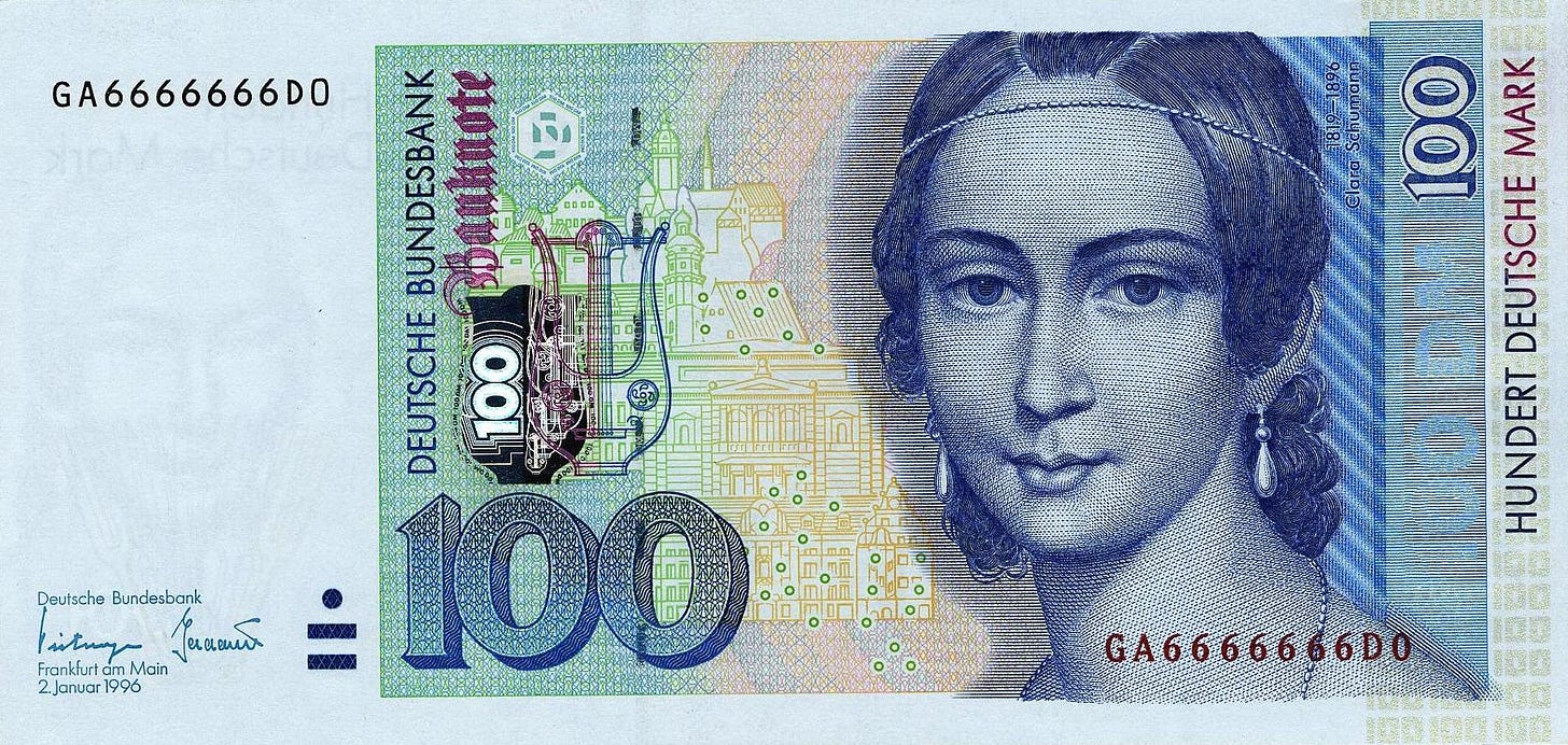 Color photo of a German bank note featuring a head shot portrait of Clara Schumann as a young woman