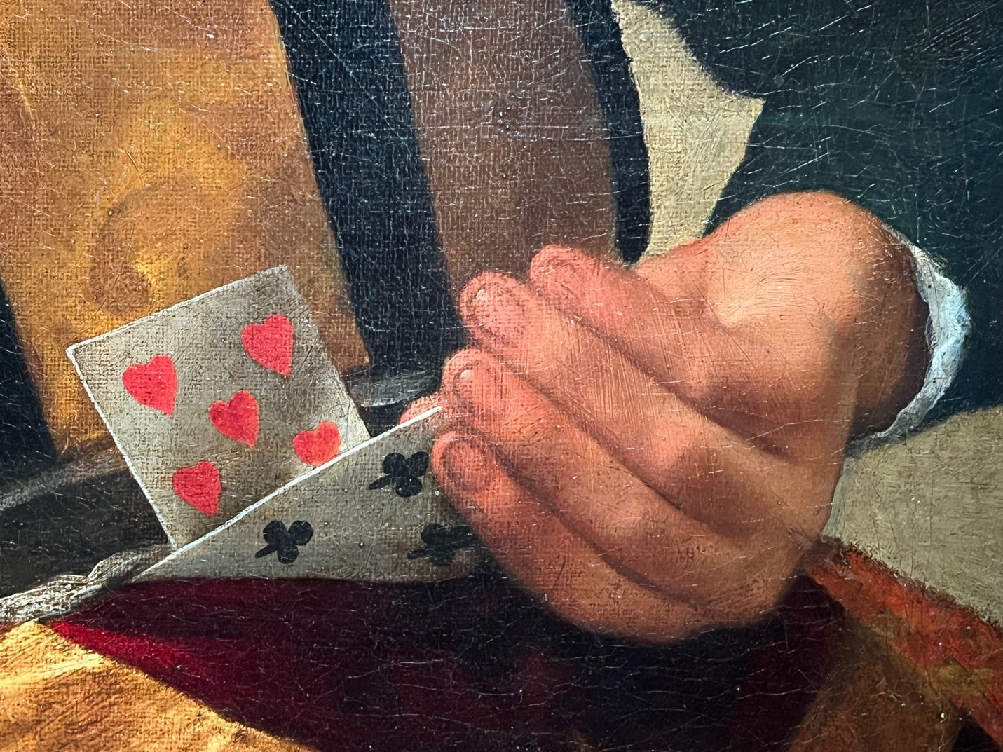 A close-up of a hand holding a card

Description automatically generated