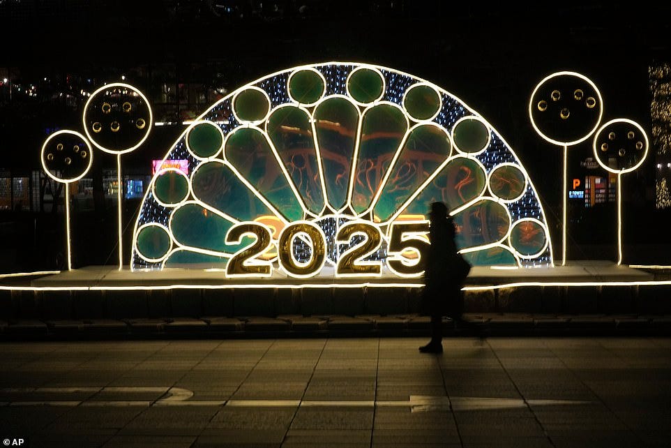 SEOUL: A woman walks near an illuminated decoration on New Year's Eve in Seoul, South Korea