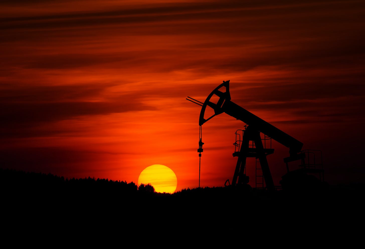 View of an pump extracting oil as the sun sets
