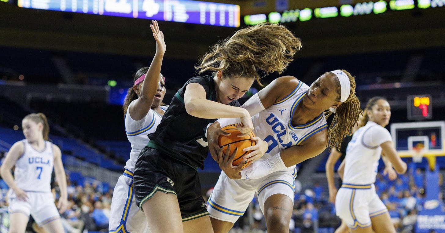 UCLA forward Janiah Barker battles Cal Poly forward Nora Perez to force a jump ball at Pauley Pavilion.