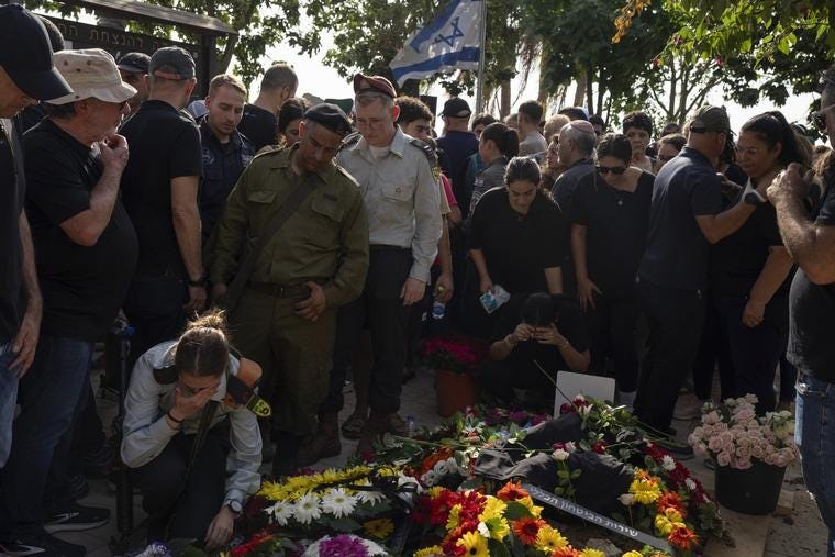 Mourners attend the funeral of Erik Kraunik, the chief of security of Kibbutz Be'eri, at Yehud cemetery, in central Israel, on Oct. 23. Kraunik was killed by Hamas militants at Kibbutz Be'eri near the border with the Gaza Strip. More than 1,400 people were killed and more than 200 taken captive in an unprecedented multi-front attack by the militant group.