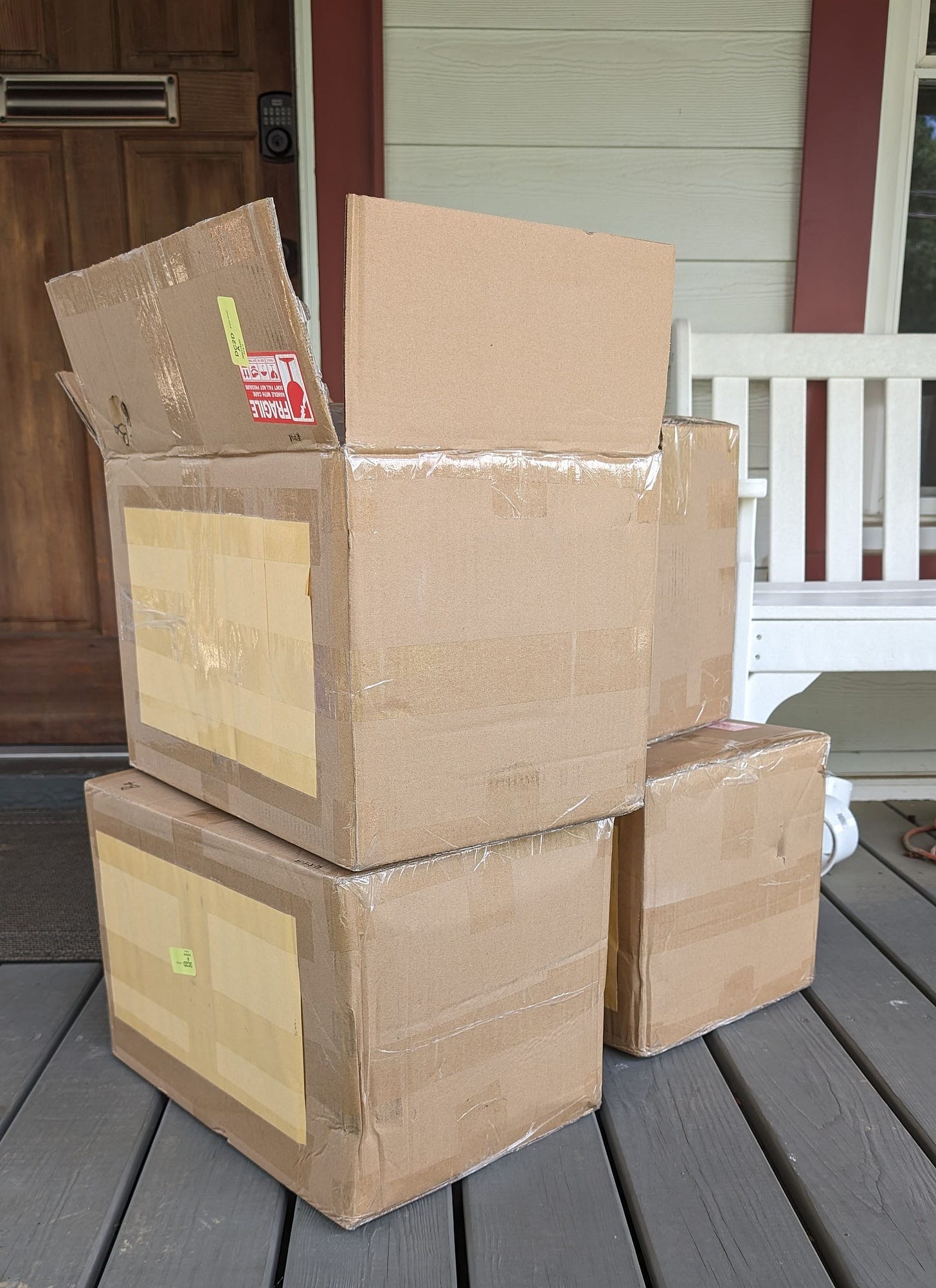Four cardboard boxes on a porch