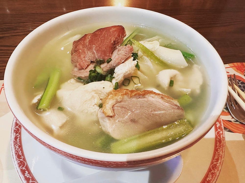 A large bowl of wanton soup with pork and vegetables at Madam Tusan in Lima, Peru