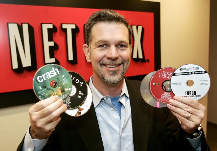 Reed Hastings, CEO of Netflix Inc., the online DVD-rental service, holds several DVDs as he poses at the Netflix offices in Beverly Hills, California, December 8, 2005. [Netflix has come out on top in a yearlong struggle against rival Blockbuster Inc. ]