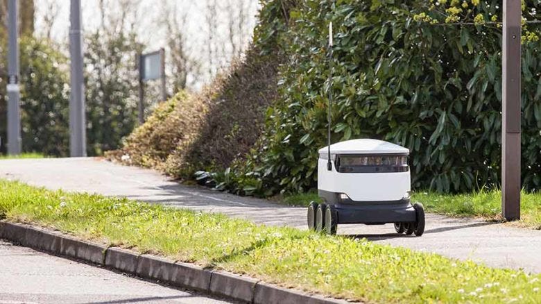 A Starship robot delivery unit on the footpath.