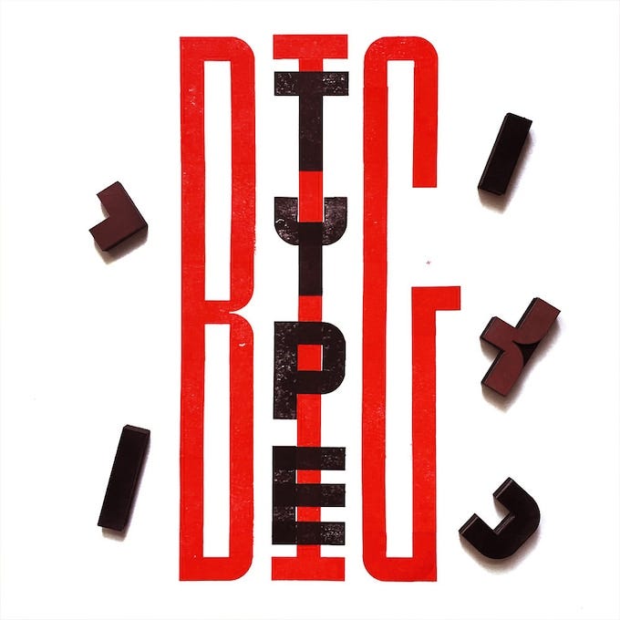 the words "BIG TYPE" stamped in elongated letters in red and black