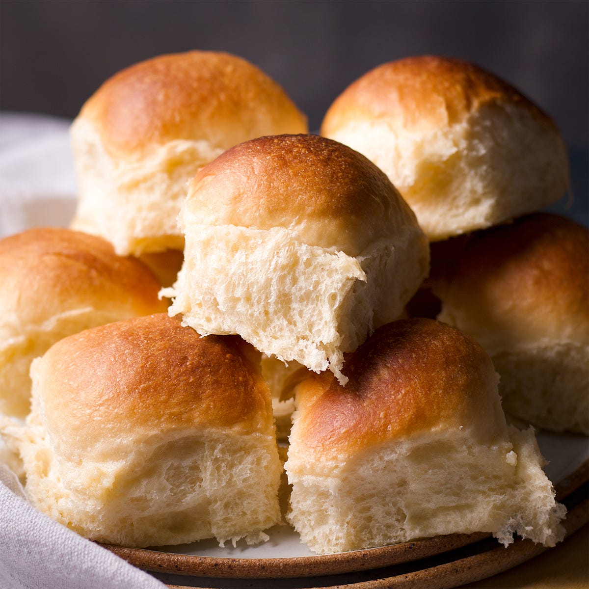 A plate full of homemade dinner rolls.