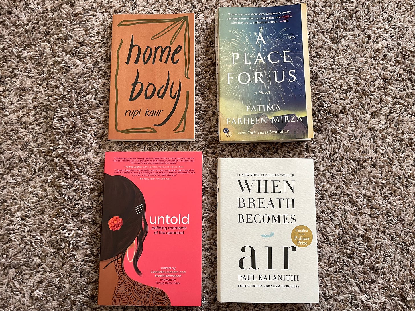 Four books shown atop a beige carpet: Rupi Kaur’s Home Body, Fatima Farheen Mirza’s A Place for Us, Brown Girl Magazine’s Untold, and Paul Kalanithi’s When Breath Becomes Air. 