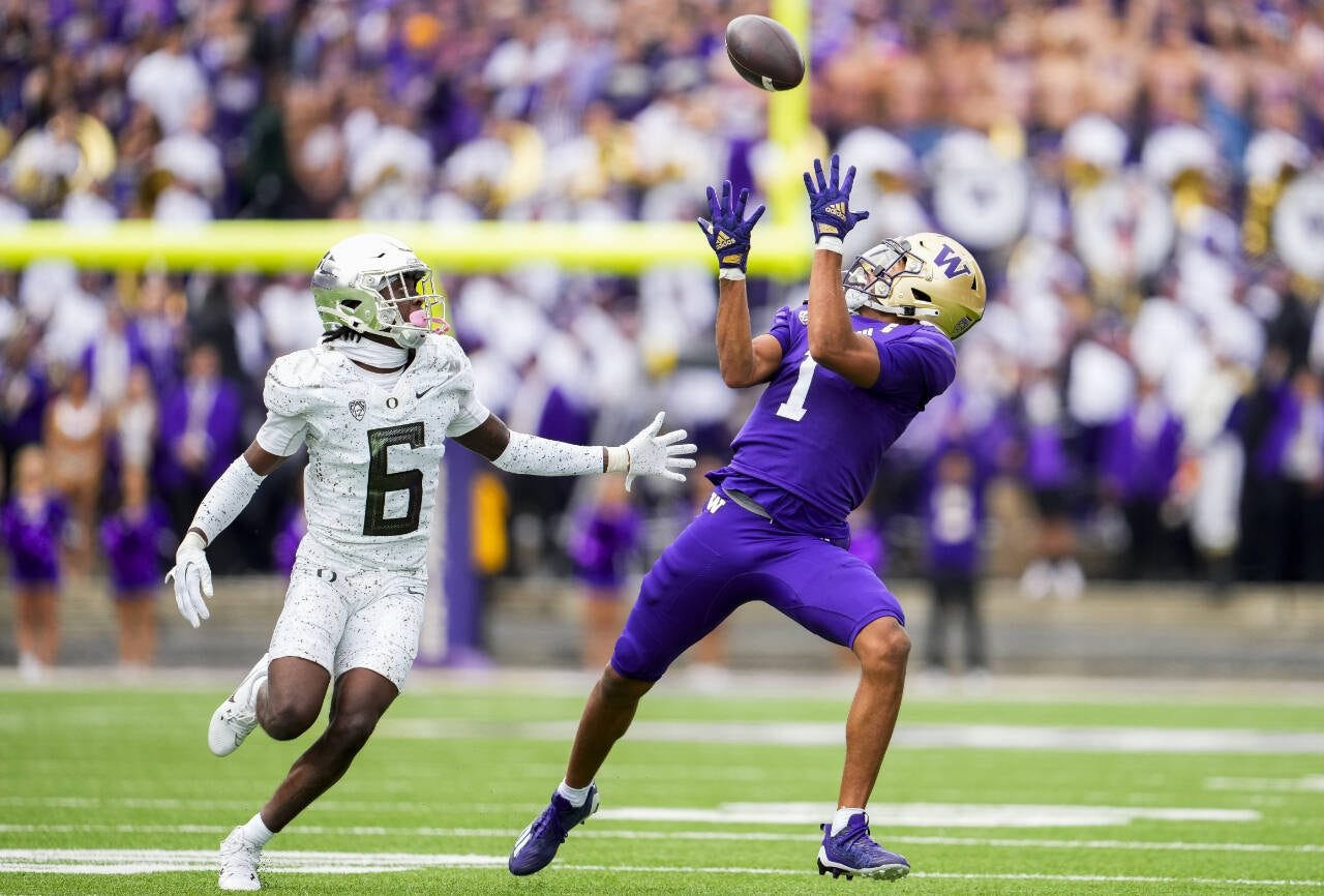 Washington wide receiver Rome Odunze (1) makes a catch in front of Oregon defensive back Jahlil Florence (6) during a game Oct. 14 in Seattle. (AP Photo/Lindsey Wasson)