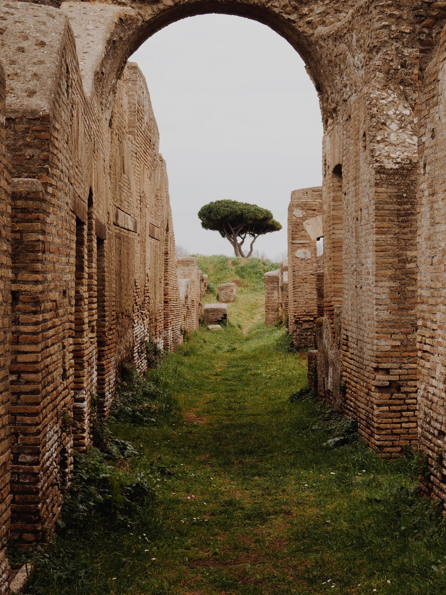 Photo of path under brick archway by Anastasia Zhenina from Pexels