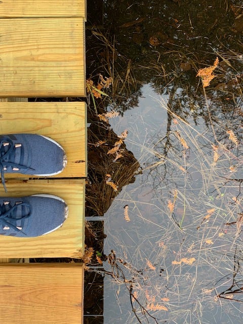 Kelly's image of her feet on a bridge over some water. 