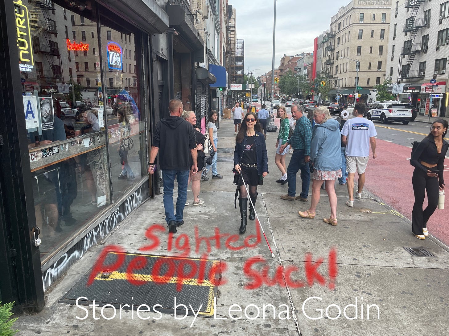 Leona Goldin, a white woman using a cane on a sidewalk in NYC, is surrounded by sighted people staring at her.