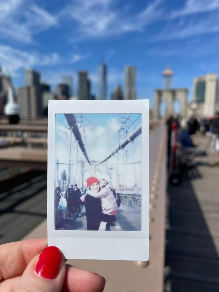 polaroid of mother and daughter on the Brooklyn Bridge.