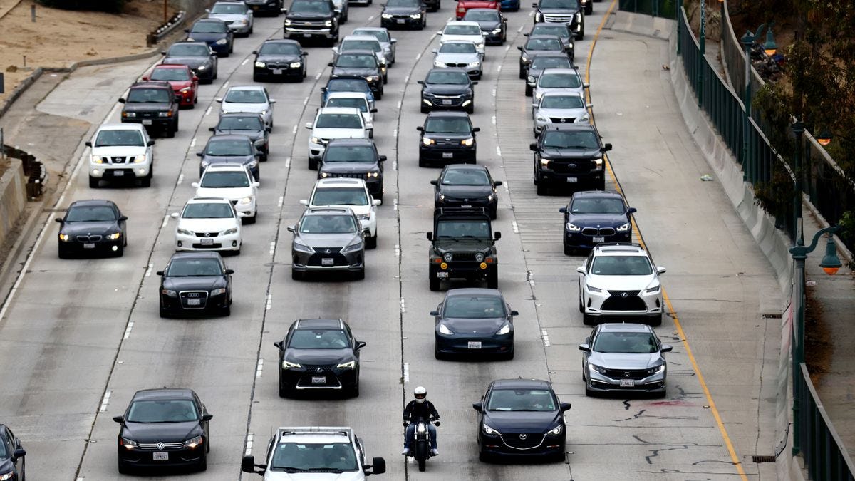 Vehicles crowd a five-lane highway in Los Angeles.
