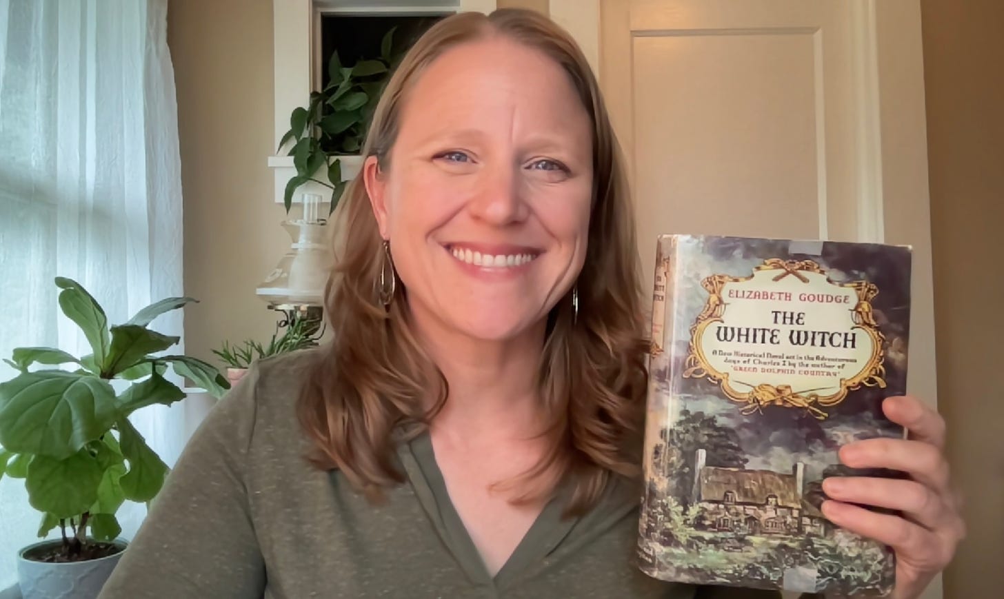 Julie Witmer with a US edition of The White Witch by Elizabeth Goudge