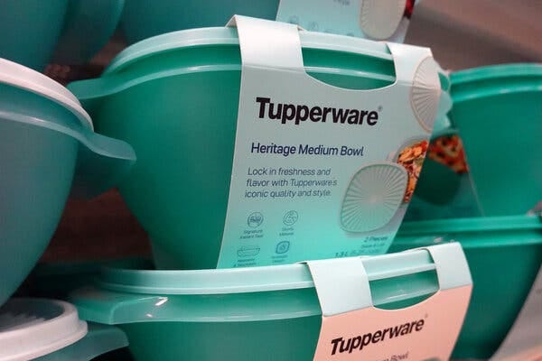 Stacks of green plastic containers with “Tupperware” labels.