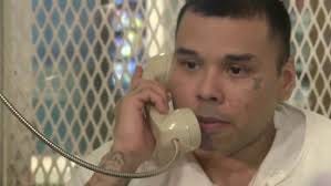 Ramiro Gonzales speaking with media through a prison telephone.