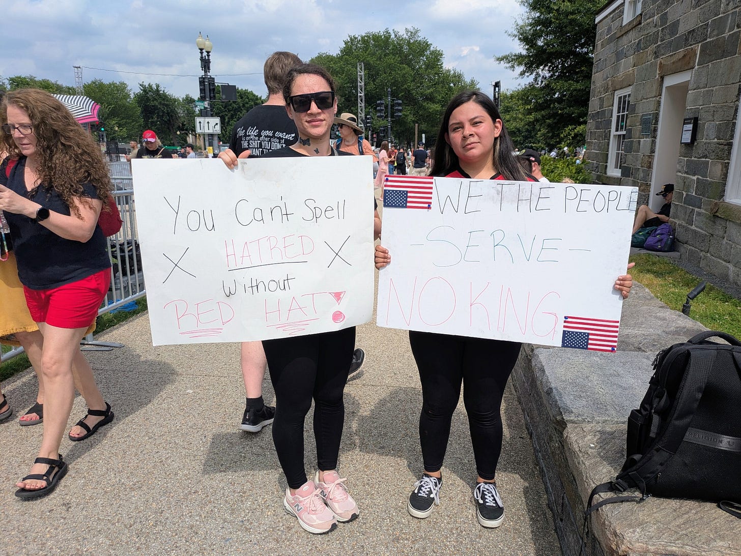 Angelica Zetino, 24, and Shoshauna Brooks, 27, from Rockville and Gaithersburg, Maryland, stood out among the crowd as they carried signs protesting Trump's administration, particularly recent immigration raids, at the U.S. Army parade in Washington, D.C. on June 14, 2025. (Photo by Ashley Murray/States Newsroom) Angelica Zetino, 24, and Shoshauna Brooks, 27, from Rockville and Gaithersburg, Maryland, stood out among the crowd as they carried signs protesting Trump's administration, particularly recent immigration raids, at the U.S. Army parade in Washington, D.C. on June 14, 2025. (Photo by Ashley Murray/States Newsroom)