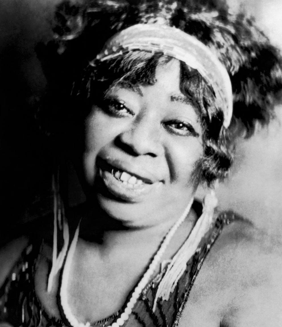 black & white portrait of Rainey in a pearl necklace and sporting a gold tooth