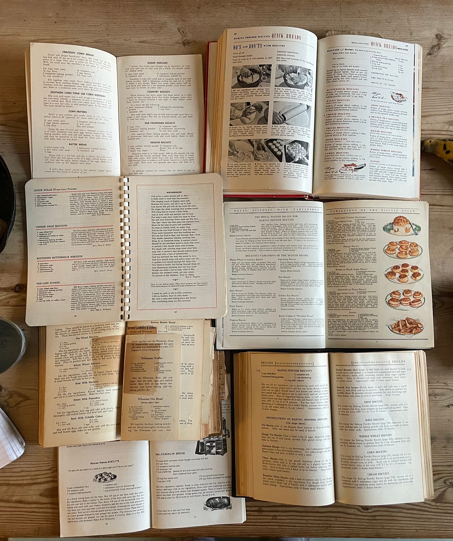 an array of open cookbooks on a wooden surface