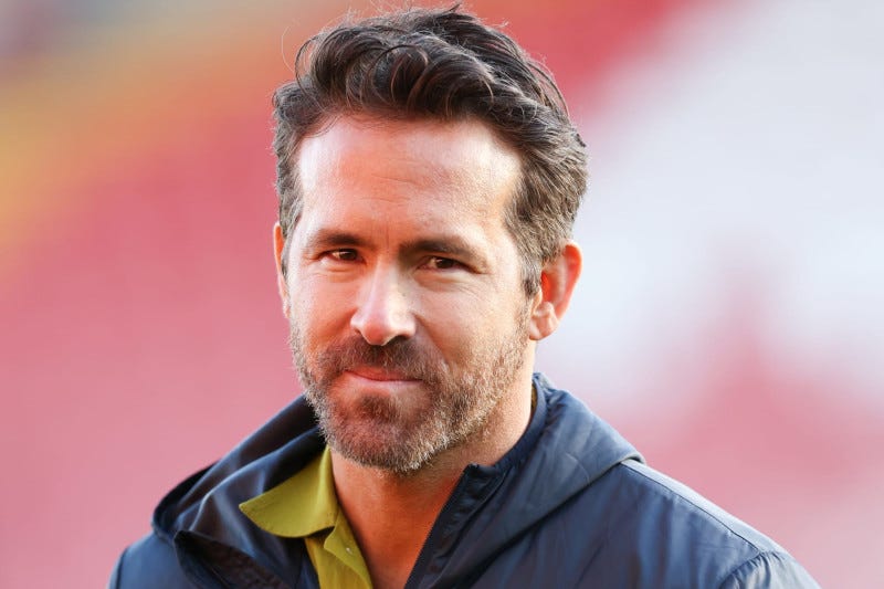 WREXHAM, WALES - MARCH 25: Wrexham co-owner Ryan Reynolds wearing a Wrexham jacket during the Vanarama National League match between Wrexham and York City at the Racecourse Ground on March 25, 2023 in Wrexham, Wales. (Photo by Matthew Ashton - AMA/Getty Images)