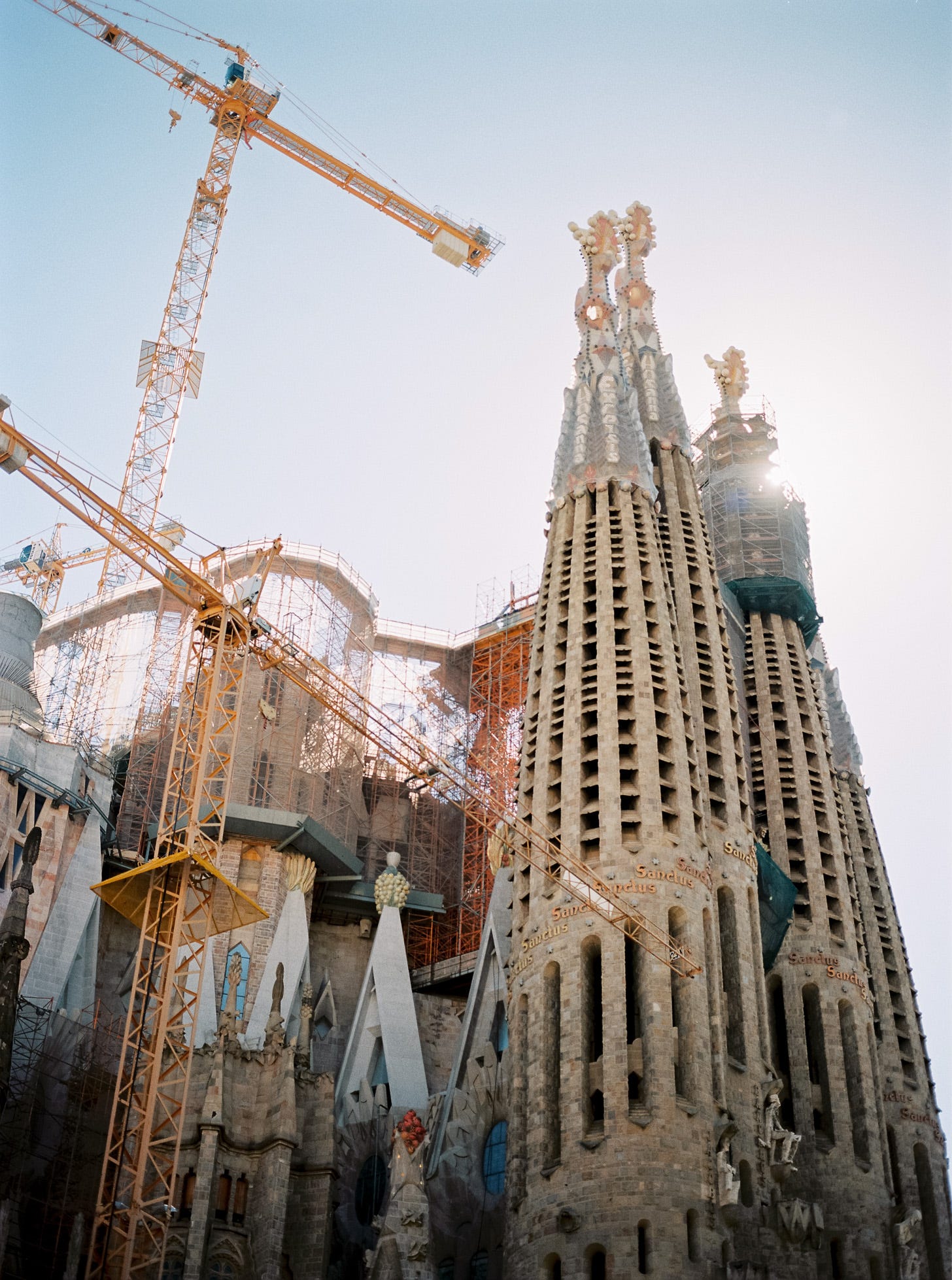 Photo of the Sagrada Familia in Barcelona, surrounding by cranes and scaffolding