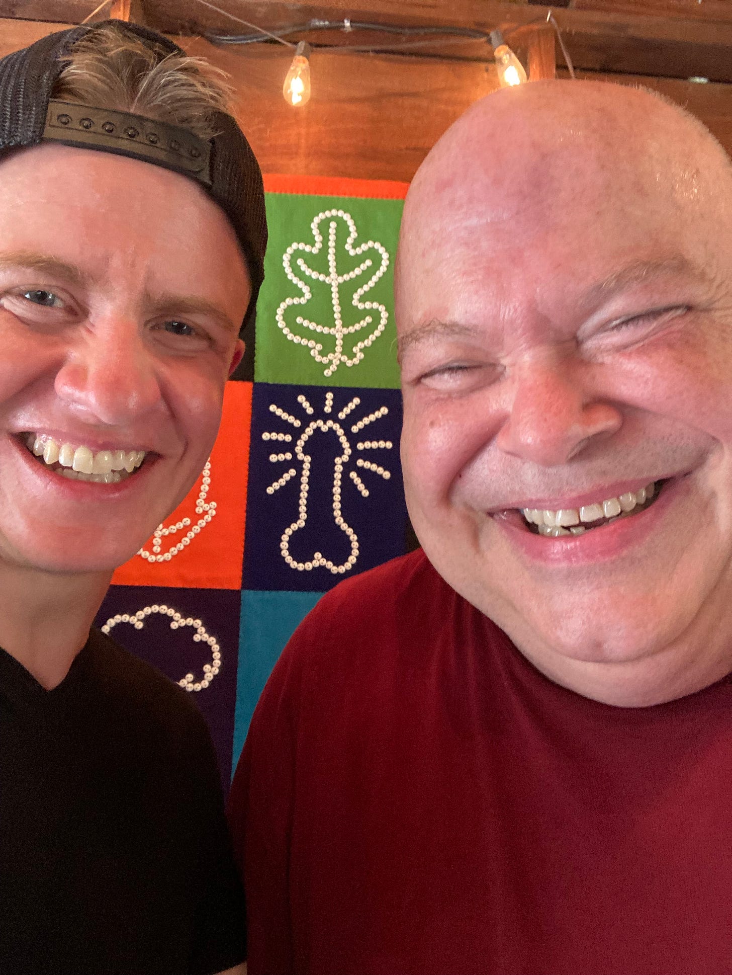 A smiling selfie of poets Luke Hathaway and Kirby