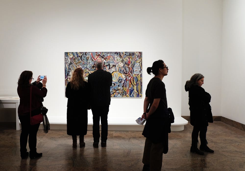 people at a museum looking at art