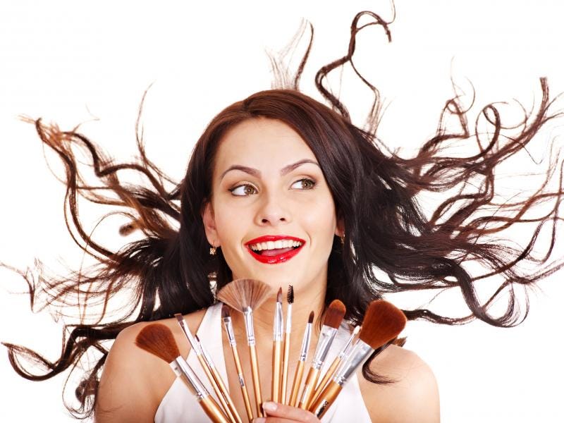 woman using makeup brush