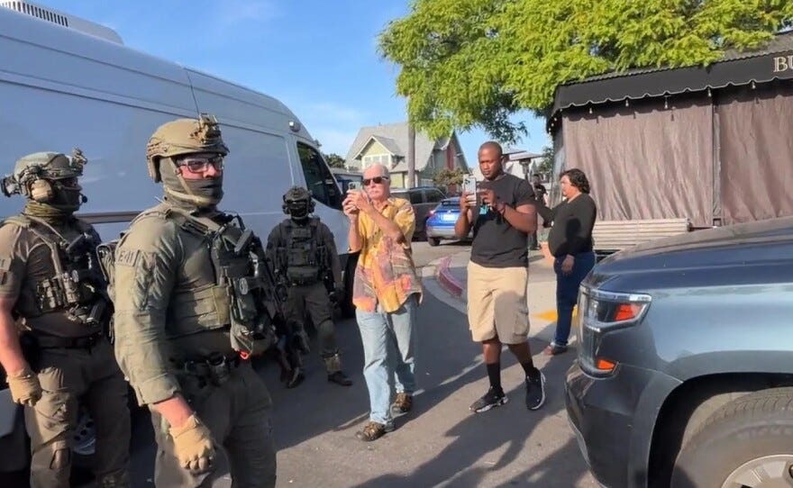 U.S. Immigration and Customs Enforcement agents execute a criminal search warrant on Friday, at the Buona Forchetta Italian restaurant in San Diego.