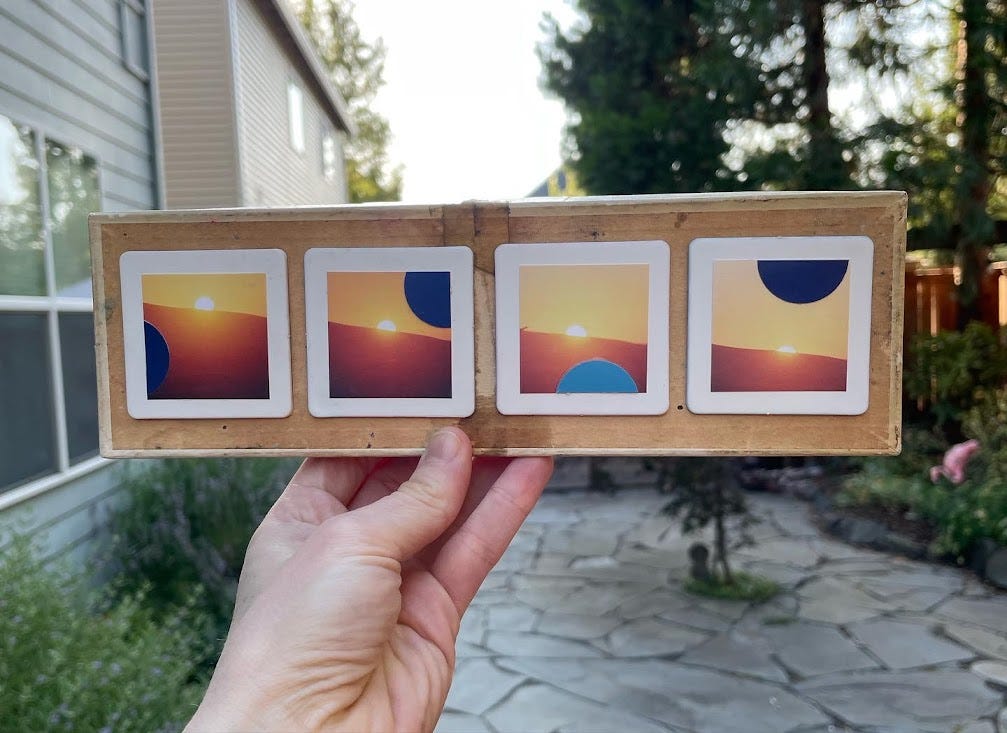 a white woman's hand holds a mixed media collage that is horizontally oriented and shows four views of the setting sun juxtaposed against circular cutous